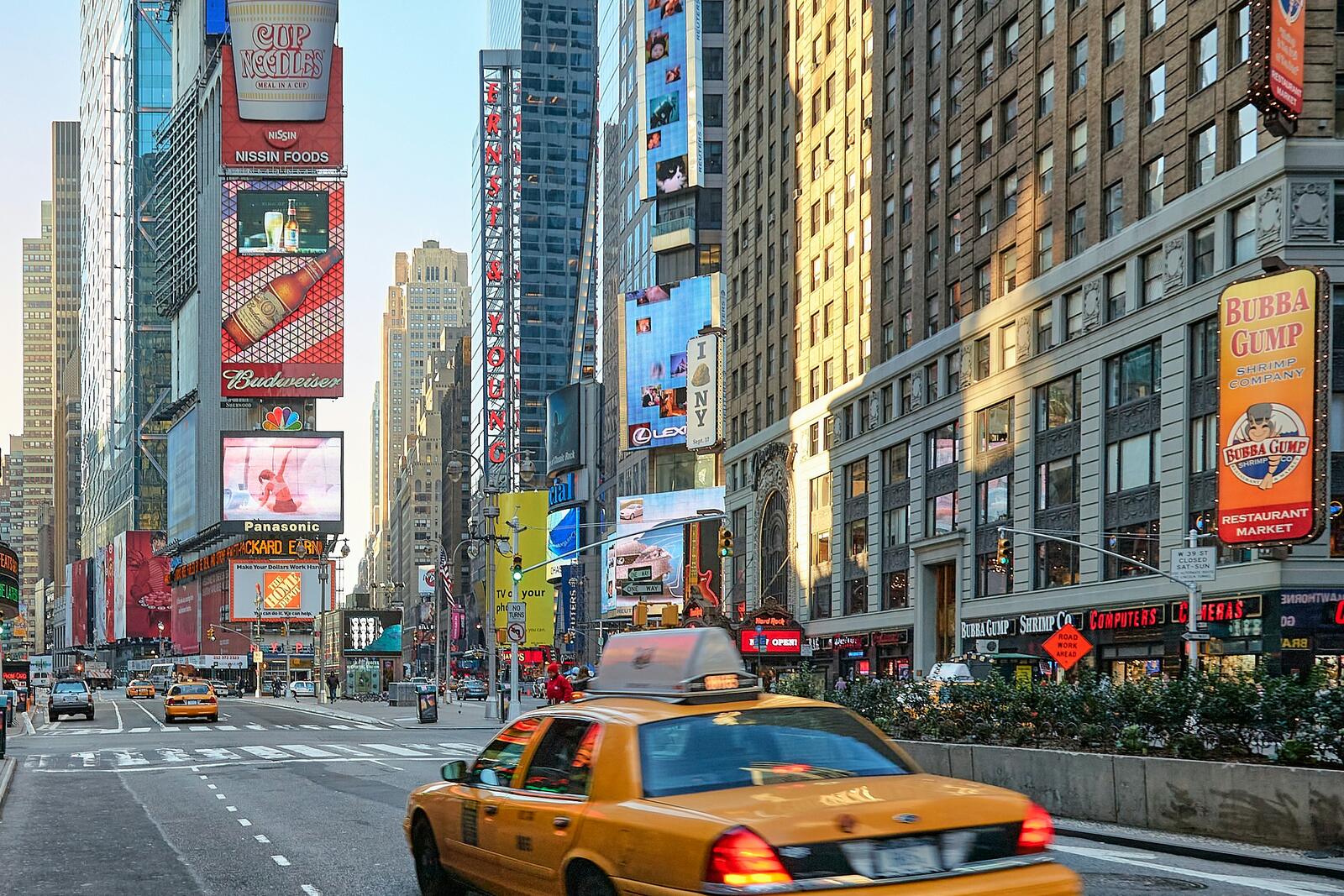Yellow taxis and illuminated billboards along Times Square in Manhattan.